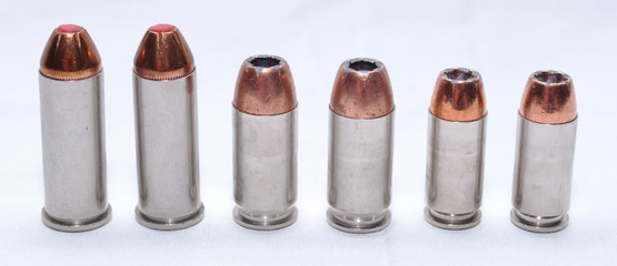 Six bullets lined up with a white background