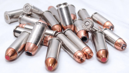 357 magnum, 40 caliber and 44spl stainless ammo on a white background