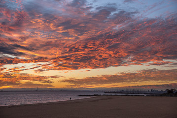 Fototapeta na wymiar impressive sunset sky with red abstract clouds at Brighton Beach, famous place near Melbourne city, Australia