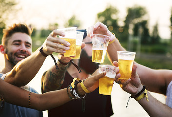 Group of Friends Drinking Beers Enjoying Music Festival Together