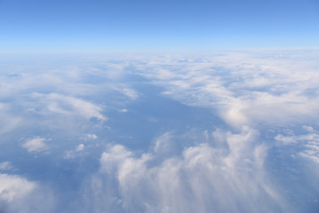 Aerial view of white clouds in the blue sky, Beautiful view from airplane window