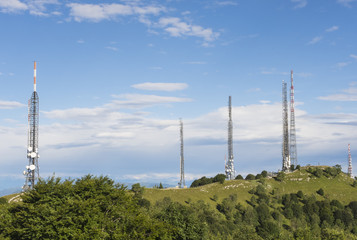 Group of towers for telecommunications on the top of the mountain. Electromagnetic and...
