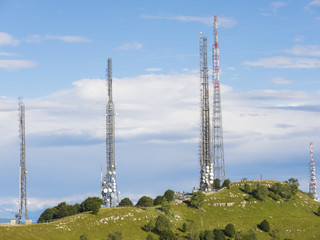 Group of towers for telecommunications on the top of the mountain. Electromagnetic and environmental pollution. Linzone mountain pick. Orobie Prealps. Italy