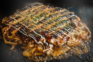 お好み焼き Okonomiyaki is a Japanese-style pancake