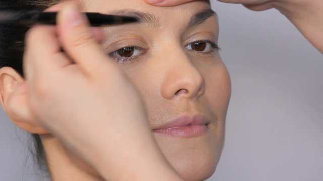 Eyes close up. Beautiful eye makeup. Makeup artist makes a beautiful makeup to a girl.