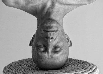 Portrait of a man standing on his head 