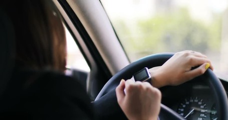 Closeup of woman girl using smart watch on her hands while driving a car, vintage tone, urban background, technology innovation 4k