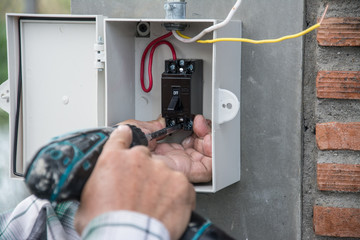 installing electric system on wall  in construction site  ,outlet with iron pipes