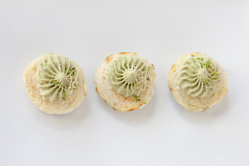 Mini cauliflower casseroles with avocado cream on a white plate