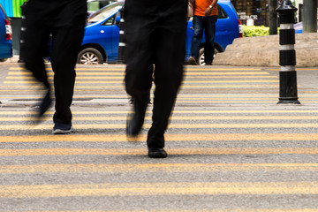 Motion Blur - People crossing the road. Blurry effect to illustrate movement