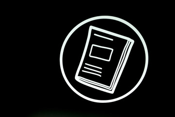 White book icon on black background.