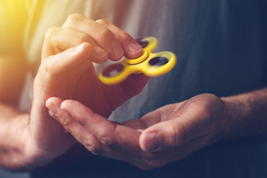 Man playing with fidget spinner