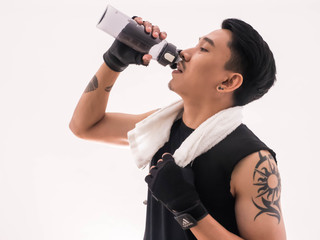 Young handsome drink water after exercise.