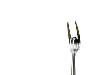 Stainless steel fork is gesture meant to convey love on white background.