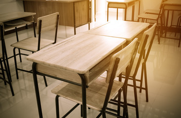 School empty classroom with desks chairs wood in high school thailand, vintage tone education concept