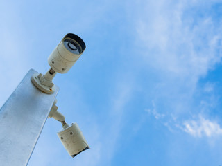 Closed-circuit television or CCTV Security camera on blue sky background