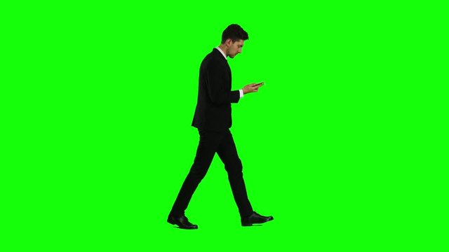 Man goes to work and talks on the phone. Green screen. Side view