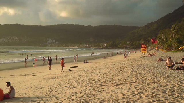 Patong Phuket beach with dark clouds and yellow sunlight - before the rain