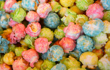 Multicolored glazed popcorn, sweetness, texture, background