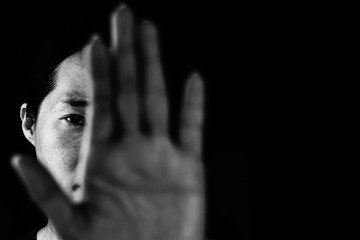 woman behind palm of hand, stop bullying in white tone, abuse concept