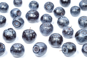 Fresh blueberries on the white frozen surface.