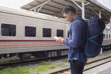 man traveler with backpacker look searching location in tablet, travel concept