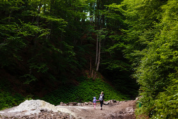 Obraz premium Mother and daughter go camping on a mountain