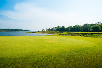 green grass field with lake in public park