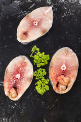 fresh scomberomorus fish placed on black slabs. In supermarket