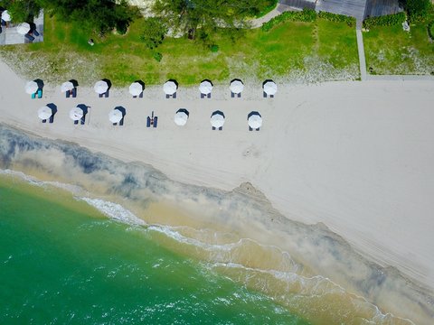 Empty sand beach with white umbrellas, Langkawi island, Malaysia