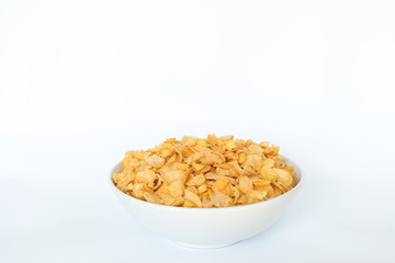 Cornflakes in porcelain bowl isolated on white background