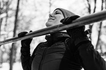 Fototapeta na wymiar Female athlete exercising in park in winter