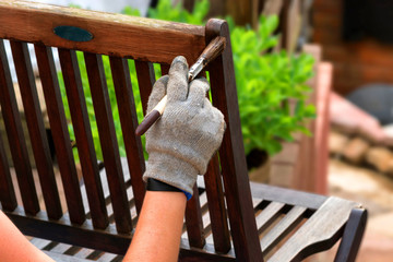 Women hand with brush strokes wooden furniture