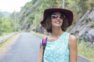 portrait of girl with sunglasses and hat in shorts