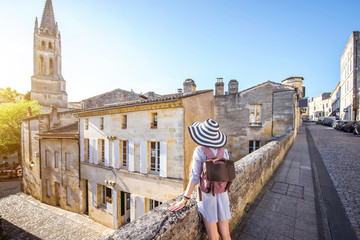 Young woman tourist walking old street at the famous Saint Emilion village in Bordeaux region in...