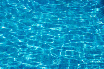 Swimming pool surface with clean blue water. Summer background.