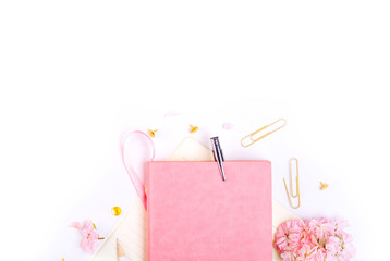 Workplace mockup with pink leather notebook, glasses and golden accessories top view. Flat lay with copy space.  Feminine working style concept.