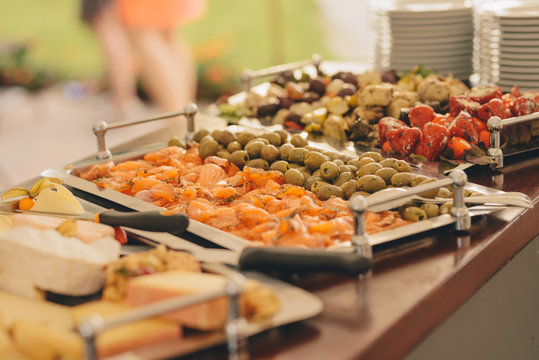plate with appetizer : artichokes, smoked salmon, peppers, olives , catering