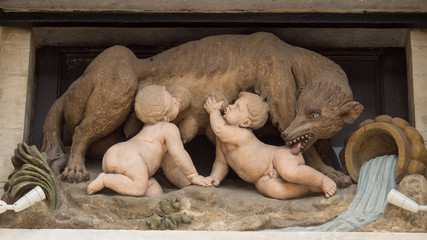 Public stone sculpture of Romulus and Remus drinking milk from the female wolf on Grand Place, Brussels, Belgium.