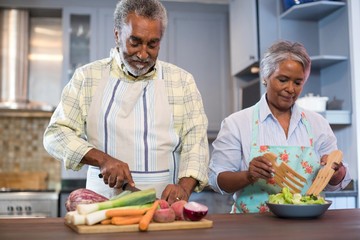 Senior couple preparing food at home