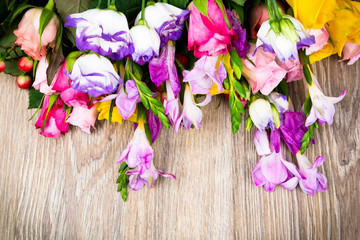 Photo of mixed beautiful flowers on wooden background