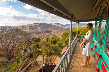 Beautiful woman looks at the landscape of Madagascar from the Tranofitaratra meeting room on the royal hill Ambohimanga in Madagascar