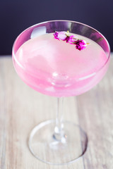 Alcoholic Pink Berry Cocktail with Rose Flowers, Vertical Close-up View from Above