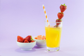 glass of refreshing drink: orange juice with strawberries