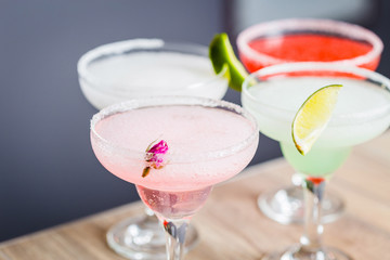 Different Kind of Cocktails garnished with Fruits, Strawberry, Lime, Pineapple and Rose Flower Cocktails, Focus on Foreground, Horizontal View