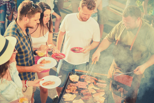 Friends having a barbecue party at backyard