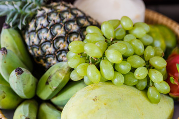 Set of fresh tropical fruits including grape  banana pineapple  mango coconut