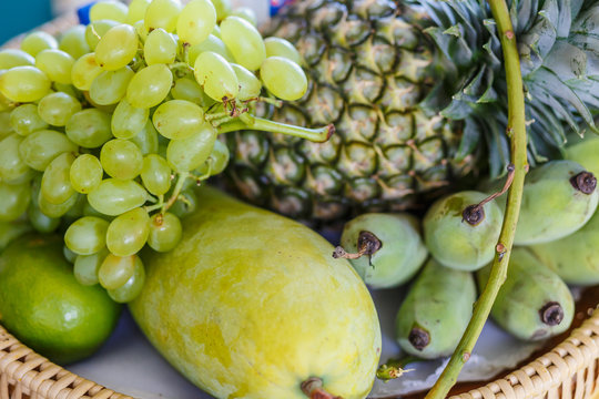 Set of fresh tropical fruits including grape  banana pineapple  mango coconut