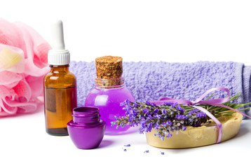 Obraz na płótnie Canvas Lavender oil and purple wellness set with flowers