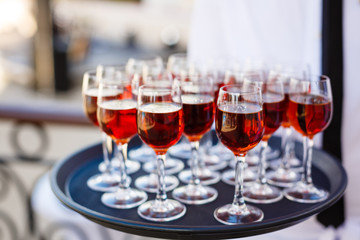 Glasses with cognac on a black tray. Cocktail Reception